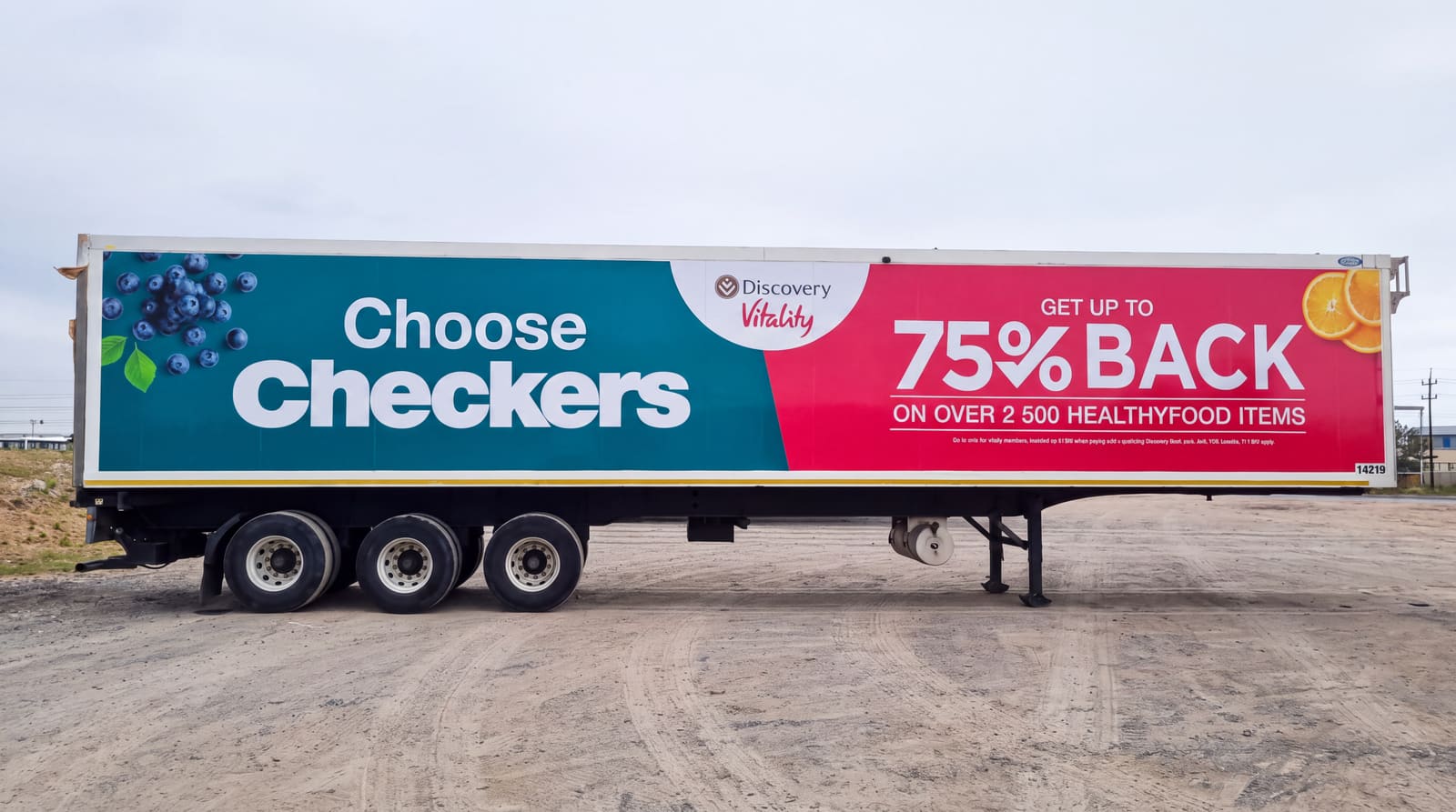 Large-format trailer graphics reading Choose Checkers with blueberries and citrus