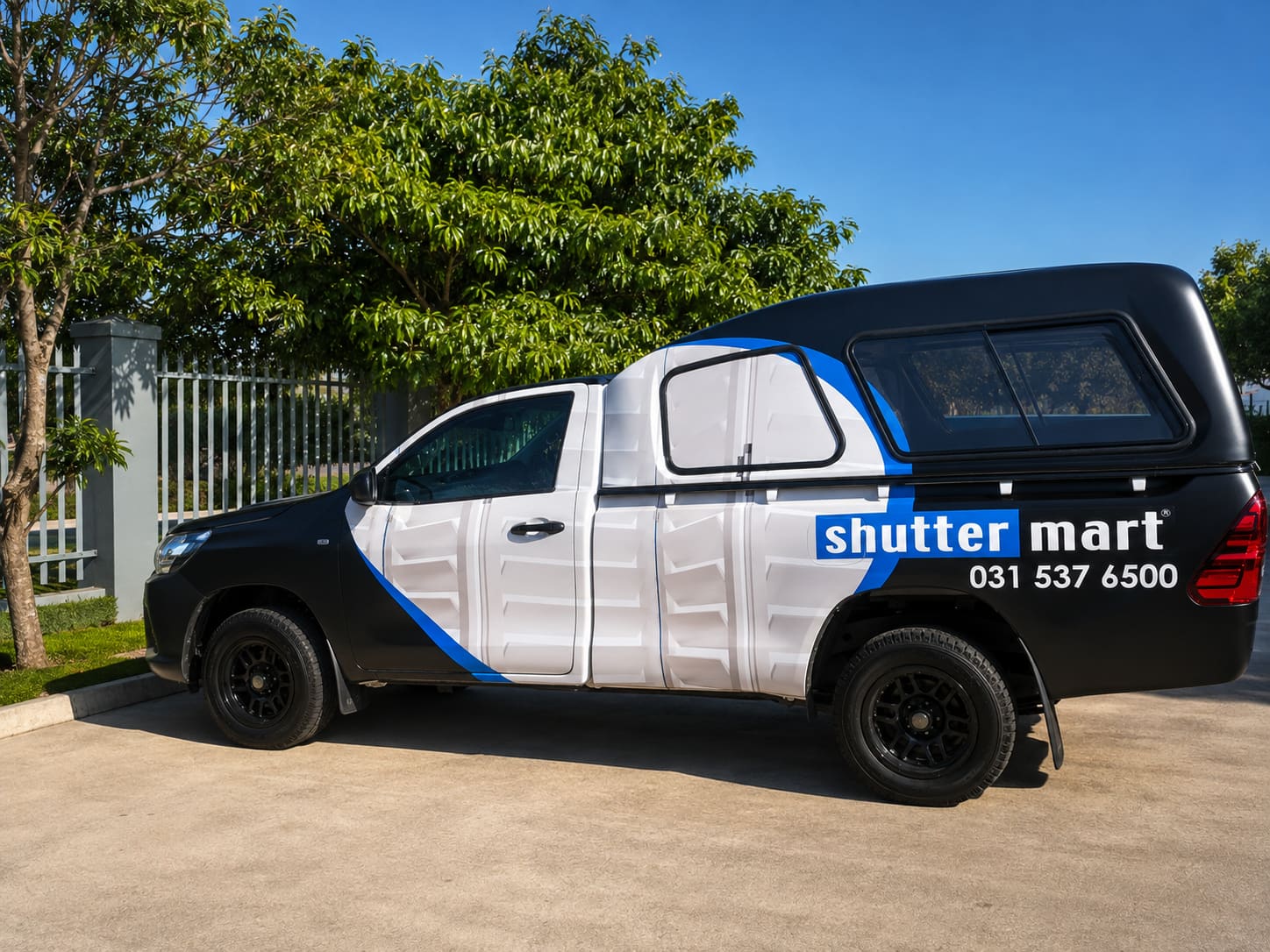 Toyota Hilux with a black and white Shutter Mart vehicle wrap